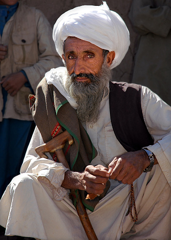 A small town between Chaghcharan and the Minaret of Jam, Ghor Province, Afghanistan: An old Afghan man with a long grey beard and white turban in Central Afghanistan near Chaghcharan.
