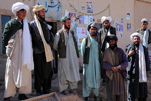 A small town between Chaghcharan and the Minaret of Jam, Ghor Province, Afghanistan: Local Afghan men with turbans in a village in a remote part of Central Afghanistan near Chaghcharan.