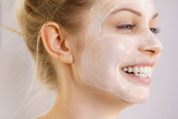 istock Girl with cream moisture cosmetic on face 1450290513