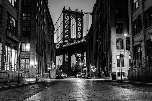 New York City, United States – May 31, 2019: A grayscale shot of the Manhattan Bridge from Washington Street Dumbo