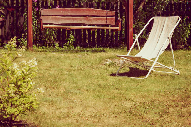 istock Garden with deck chair and swing 1450292765