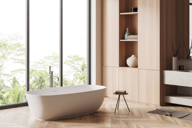 istock Corner view on bright bathroom interior with bathtub, panoramic window 1450293731