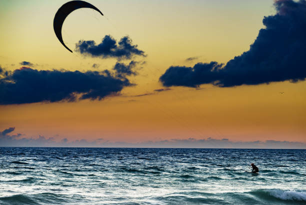 istock Kite surfer riding waves. Kiteboarding sport. 1450293851