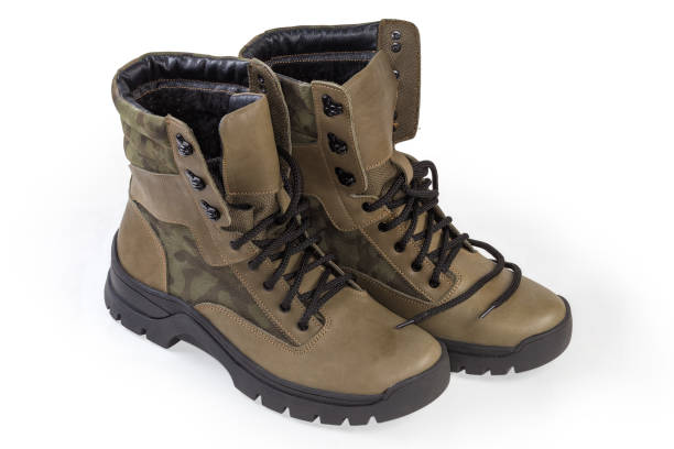 istock Pair of winter leather combat boots on a white background 1450294122