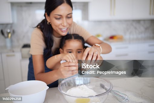 istock Egg, baking and family with a mother and girl learning how to bake in the kitchen of their home together. Food, kids and cooking with a woman teaching her daughter how to be a chef or cook in a house 1450294258