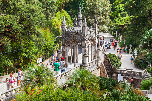 Sintra, Portugal - August 14, 2017: Tourists walk the Bridge of Quinta da Regaleira, an estate located near the historic center of Sintra old town