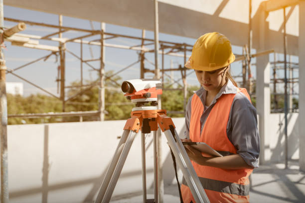 istock Female civil engineer inspecting and working on building construction site with laptop 1450296904