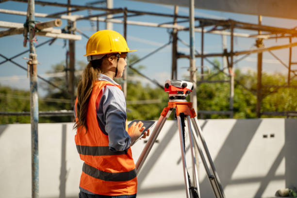 istock Female civil engineer inspecting and working on building construction site with laptop 1450296933