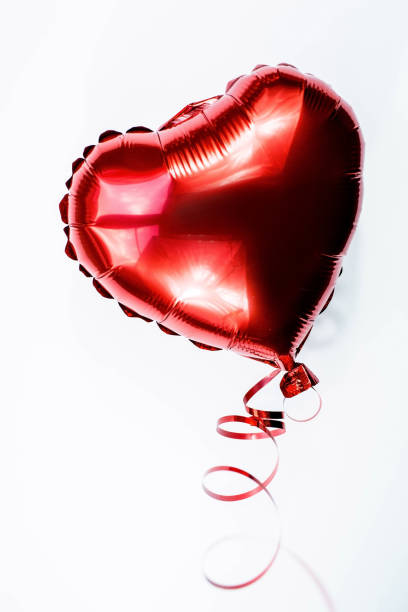 istock Banner. Red heart foil balloon on white Valentines Day background. Copyspace. 1450297054