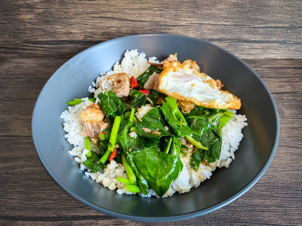 istock Crispy pork with Chinese broccoli and oyster sauce on rice and fried egg 1450298534