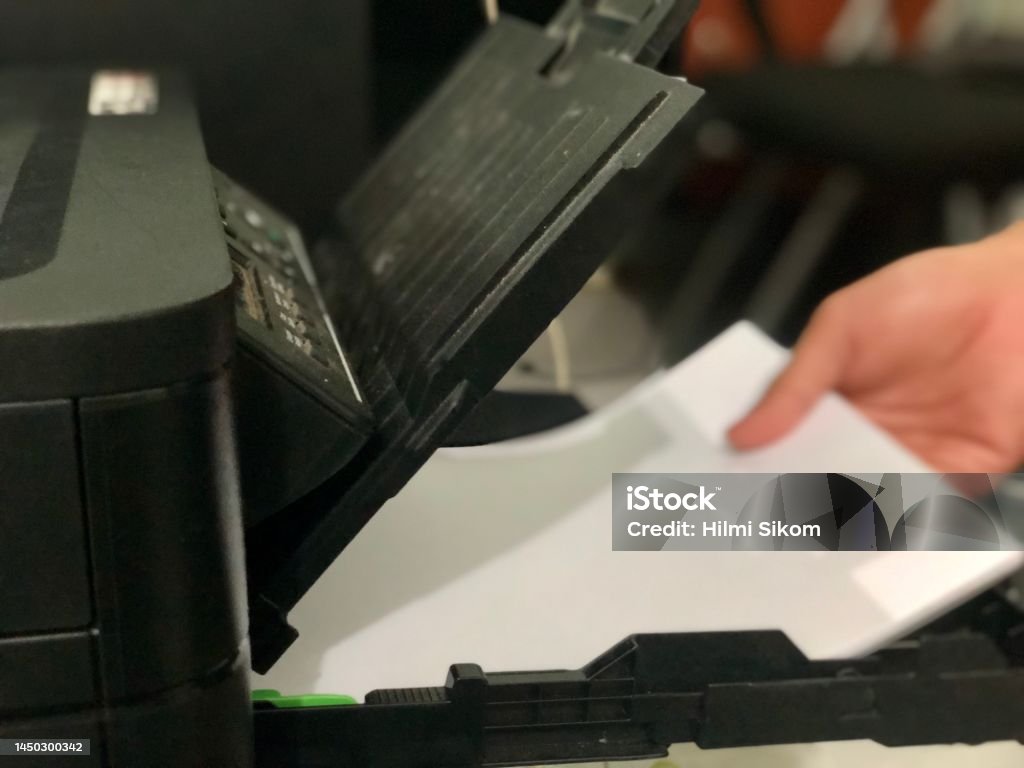Paper Into Printer A Worker Is Loading White Paper Into The Printer Stock Photo - Download ...