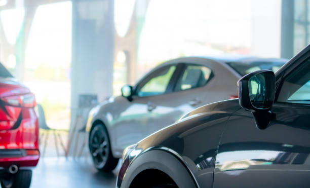 Selective focus car parked in luxury showroom. Car dealership office. New car parked in modern showroom. Car for sale and rent business. Automobile leasing and insurance concept. Electric automobile. stock photo
