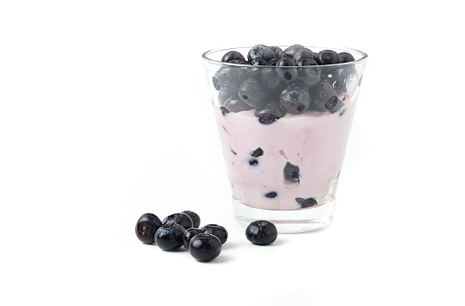 Blueberries fruit with yogurt in glass isolated on white background.High vitamin Anthocynins benefit for heart and blood circulatory system