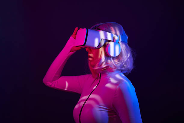 istock Woman in virtual reality goggle in neon colors. 1450304318