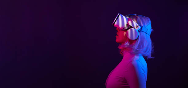 istock Woman in virtual reality goggle in neon colors. 1450304580