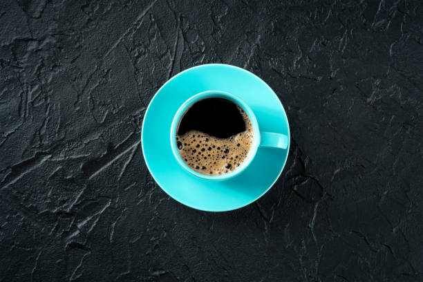 istock Coffee cup, overhead flat lay shot on a black slate background 1450304606