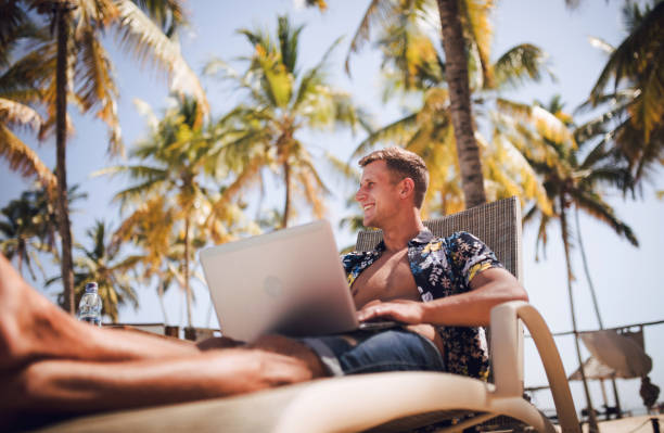 istock young digital nomad man at sea traveling with a computer 1450305799