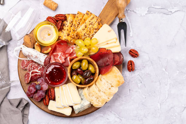 istock Antipasto board with prosciutto, salami, crackers, cheese 1450306328