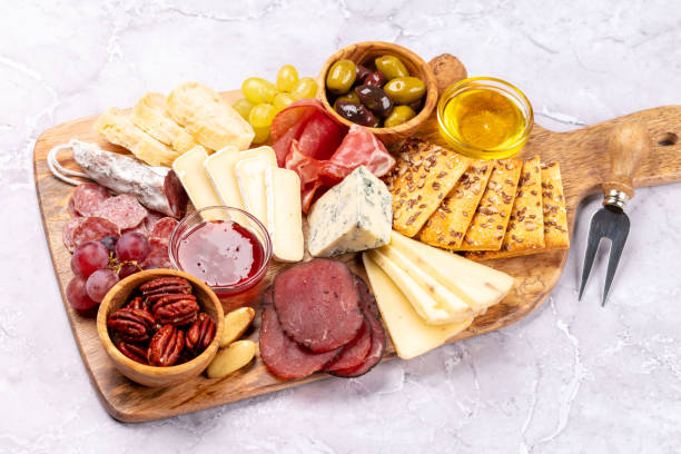 istock Antipasto board with prosciutto, salami, crackers, cheese 1450306360