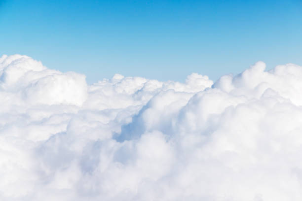istock Sunny clouds and sky from airplane 1450306403
