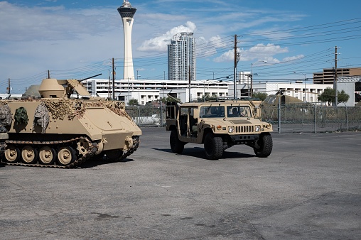Los Angeles, United States – August 03, 2022: A Humvee passing the side of an FMC A113 Armored Military Vehicle
