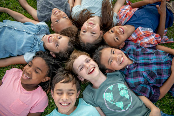 istock Kids Laying in a Circle Outside 1450308515