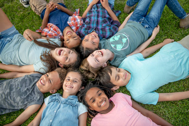 istock Kids Laying in a Circle Outside 1450308538