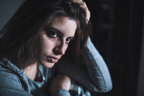 istock Sad woman with problems sitting on the ground. 1450308646