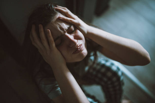 istock Frustrated woman with her head in her hands. 1450308651