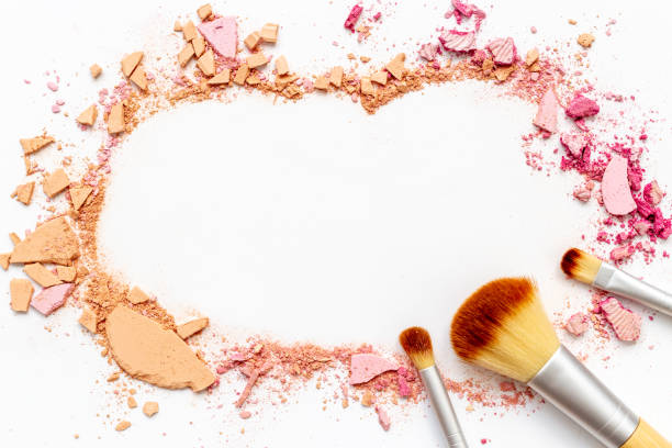 istock Nude colored makeup powder with brushes isolated on white background 1450315824