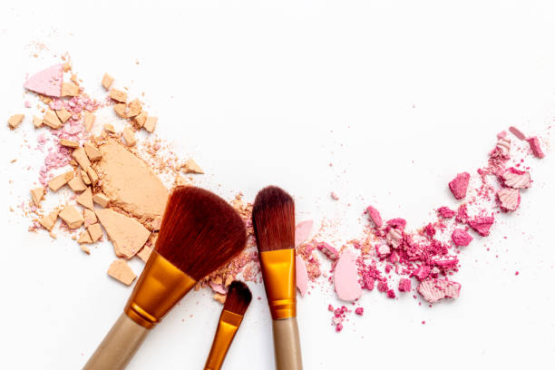 istock Crumbled makeup powder with brush isolated on white background 1450315985