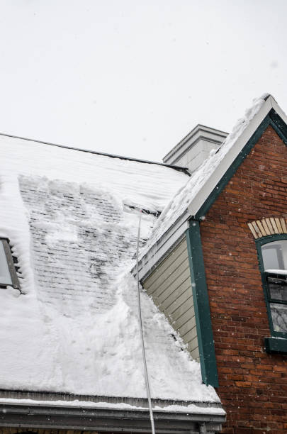 istock Long handled shovel removing snow on rooftop 1450318424