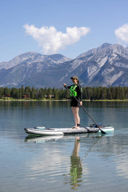 istock Woman Paddleboarding on Edith Lake, Jasper National Park, Alberta 1450318644