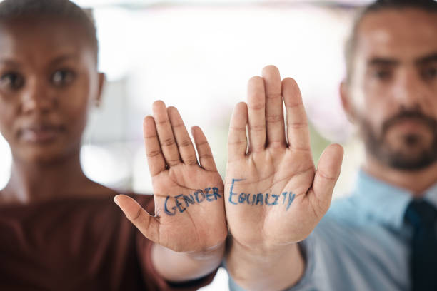 hände, gleichstellung der geschlechter und einheit mit einer zeichenbotschaft auf der hand eines geschäftsmannes und einer geschäftsfrau im büro. team, vielfalt und empowerment mit einem männlichen und weiblichen mitarbeiter, der solidarisch ist - contest togetherness human hand unity stock-fotos und bilder