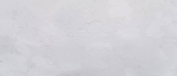 istock White cement or stone wall background and rough textured, Banner panorama 1450321488