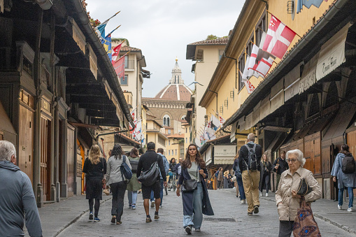 People walking over Ponte Vecchio at Florence in Tuscany, Italy