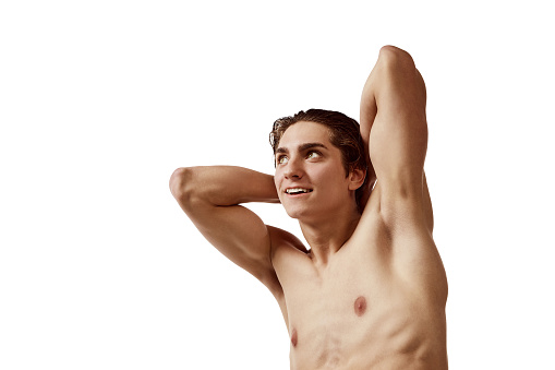 Portrait of young muscular man posing shirtless isolated over white background. Wellness. Concept of male beauty, fitness, sport, skincare, cosmetology, spa, body care. Copy space for ad