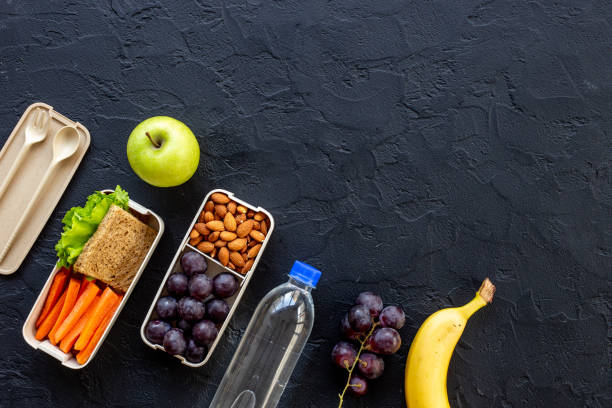 istock Food in lunch boxes with bamboo cutlery, top view 1450323314