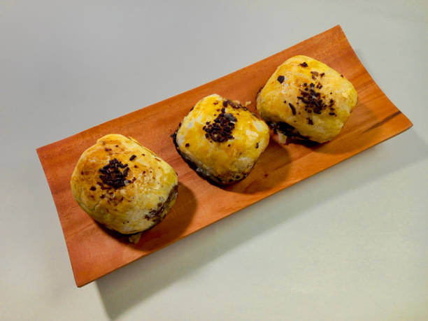 istock Bolen Pisang is a light dish made from bananas covered in rolled sheets of pastry dough. Various toppings such as cheese and chocolate. Served in white plate. Selective focus image. 1450323752