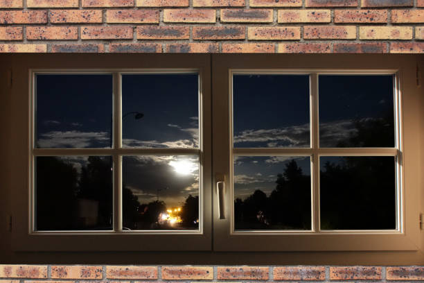 istock Moonlit night and car lights  Shot from inside an apartment through a window 1450323780