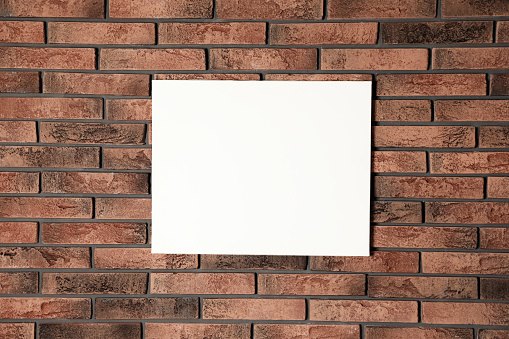 Blank canvas on brick wall. Space for design