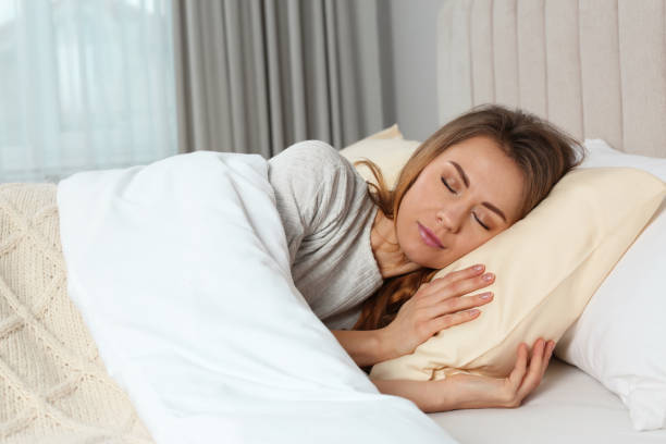 istock Beautiful woman sleeping in bed at home 1450325183