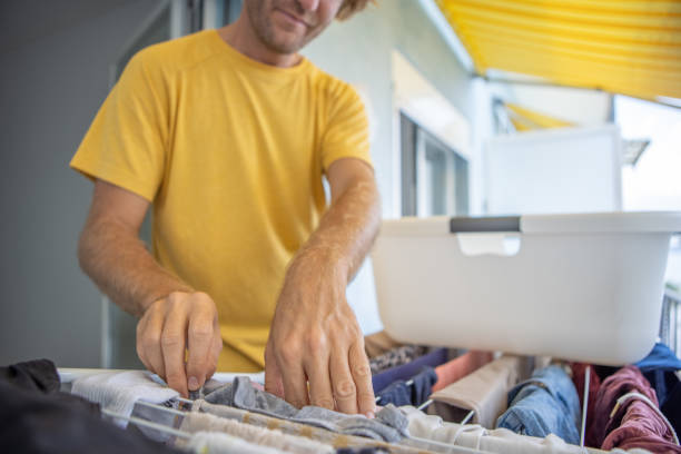 istock Man hanging laundry to dry 1450325373