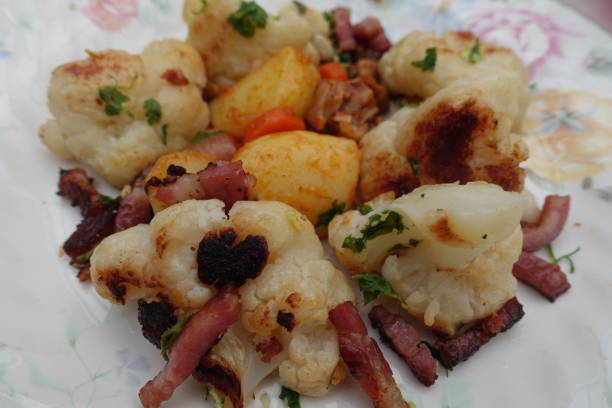 istock Roasted cauliflower and potatoes with bacon bits Meal served 1450325455