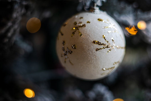 close up of white christmas ball on a christmas tree indoor