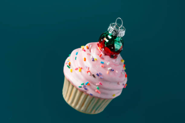 istock Christmas sweet cupcake bauble on dark green background 1450327038