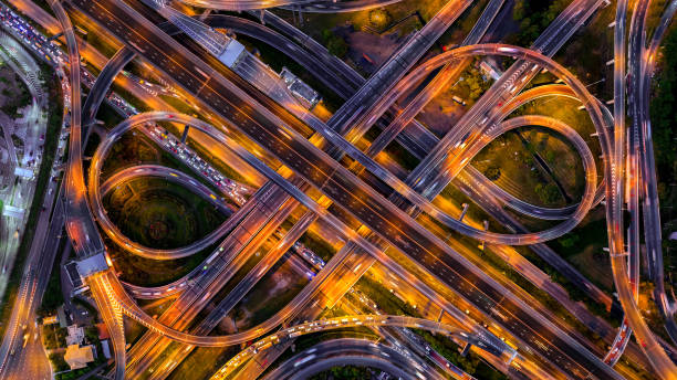 istock Aerial view of traffic on massive highway intersection at night. 1450327137