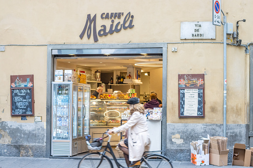 People visible outside Caffe Maioli on Via de' Bardi at Florence in Tuscany, Italy