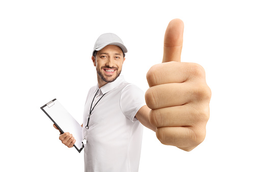 Sports coach with a whistle holding a clipboard and showing thumbs up isolated on white background