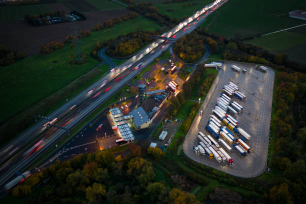 istock Highway and rest area at dusk - aerial view 1450328626